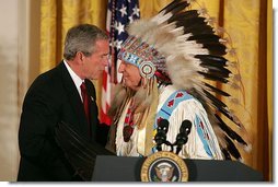 President George W. Bush greets Sen. Benjamin Nighthorse Campbell, R-Colo., during a ceremony marking the opening of the National Museum of the American Indian in the East Room Thursday, Sept. 23, 2004.  White House photo by Paul Morse