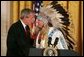 President George W. Bush greets Sen. Benjamin Nighthorse Campbell, R-Colo., during a ceremony marking the opening of the National Museum of the American Indian in the East Room Thursday, Sept. 23, 2004. White House photo by Paul Morse