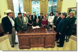 President George W. Bush signs an Executive Memorandum on Tribal Sovereignty and Consultation in honor of the opening of the National Museum of the American Indian, Thursday, Sept. 23, in the Oval Office.  White House photo by Tina Hager