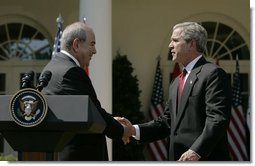 President George W. Bush shakes hands with Iraqi interim Prime Minister Ayad Allawi after their joint press conference in the Rose Garden Thursday, Sept. 23, 2004.  White House photo by Paul Morse