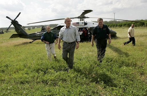 President George W. Bush and Governor Jeb Bush, right, arrive at Marty and Pat McKenna's orange grove to tour damage by the recent hurricanes in Lake Wales, Fla., Wednesday, Sept. 29, 2004. White House photo by Eric Draper.