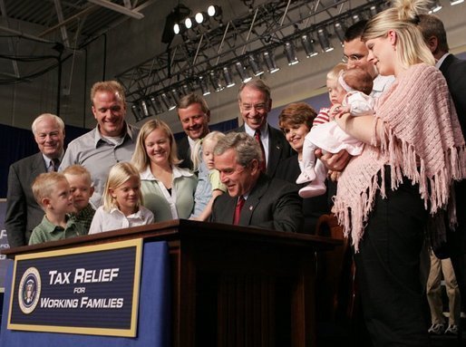 President George W. Bush signs H.R. 1308, the Working Families Tax Relief Act of 2004 at the South Suburban YMCA in Des Moines Iowa, Monday, Oct. 4, 2004. White House photo by Tina Hager