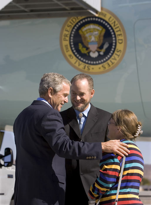President George W. Bush talks with USA Freedom Corps Greeter Frank Schnorbus and wife Robin in front of Air Force One at Reno/Tahoe International Airport, Thursday, Oct. 14, 2004. Since April 2001, Frank has been a Court Appointed Special Advocate (CASA) volunteer for abused and neglected children. White House photo by Eric Draper