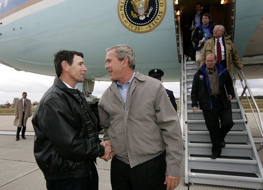 President George W. Bush meets USA Freedom Corps Greeter Jeff Kemp at Outagamie County Regional Airport in Appleton, Wisconsin, Friday, Oct. 15, 2004. For the past 12 years, Jeff has volunteered in the Oshkosh and Omro school districts. Once per week, he visits elementary school classrooms and reads to students. White House Photo by Eric Draper.