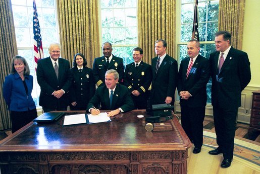 President George W. Bush signs HR 5467, The Department of Homeland Security Appropriations Act for the Fiscal Year 2005, in the Oval Office Monday, Oct. 18, 2004. White House photo by Tina Hager