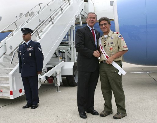 President George W. Bush meets with USA Freedom Corps Greeter Matthew Meyer, 17, in front of Air Force One in Mason City, Iowa, Tuesday, Wednesday, Oct. 20, 2004. Completing his Eagle Scout volunteer service project, Mr. Meyer helped create a local memorial dedicated to firefighters who have died in the line of duty. White House photo by Eric Draper.