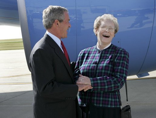 President George W. Bush shares a laugh with USA Freedom Corps Greeter Sister Chabanel Hayunga in front of Air Force One at Rochester, Minnesota International Airport Wednesday, Oct. 20, 2004. Sister Chabanel has been a volunteer with the Senior Companion program through Catholic Charities and the Southeastern Minnesota Council for Independent living. White House photo by Eric Draper.