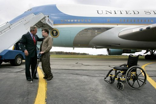 President George W. Bush talks with USA Freedom Corps Greeter Dan Yeric in front of Air Force One at Akron Canton Regional Airport in Canton, Ohio, Friday Oct. 22, 2004. Dan has been a volunteer at Akron Children's Hospital for the past 12 years and a patient at the hospital intermittently since he was diagnosed with spina bifida as an infant. White House photo by Eric Draper.