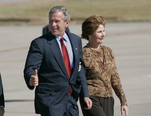 President George W. Bush and Laura Bush walk across the tarmac to Air Force One before departing Buckley Air Force Base in Aurora, Colo., Monday, Oct. 25, 2004. White House photo by Eric Draper