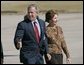 President George W. Bush and Laura Bush walk across the tarmac to Air Force One before departing Buckley Air Force Base in Aurora, Colo., Monday, Oct. 25, 2004.  White House photo by Eric Draper