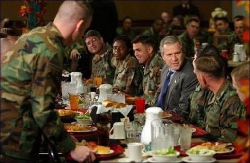 President George W. Bush enjoys lunch with U.S. soldiers at Fort Carson, Colorado. File Photo. White House photo by Tina Hager.