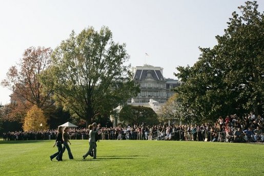 President George W. Bush and Laura Bush arrive from Texas with their daughters Barbara, left, and Jenna, right, as staff applaud on the South Lawn of the White House, Nov. 2, 2004. White House photo by Paul Morse