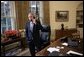 Standing at his desk in the Oval Office, President George W. Bush receives a phone call from Democratic presidential candidate John Kerry in which the senator conceded defeat in the 2004 presidential election Wednesday, Nov. 3, 2004. White House photo by Eric Draper
