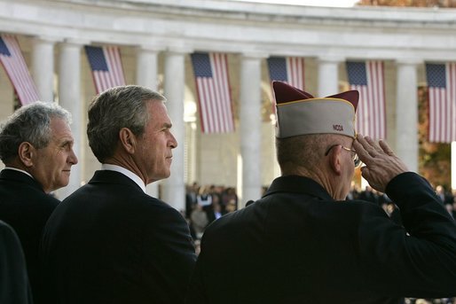 President George W. Bush stands with Secretary of Veterans Affairs Anthony Principi, left, and Mr. Gene Overstreet, President of the Non-Commissioned Officers Association, during the Veterans Day ceremonies at Arlington National Cemetery Nov. 11, 2004. "We honor every soldier, sailor, airman, Marine and Coastguardsman who gave some of the best years of their lives to the service of the United States and stood ready to give life, itself, on our behalf," said the President in his remarks. White House photo by Paul Morse