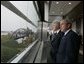 President George W. Bush and former President Bill Clinton tour the William J. Clinton Presidential Center and Park before participating in the dedication ceremony in Little Rock, Ark., Nov. 18, 2004.  White House photo by Eric Draper