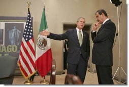 President George W. Bush talks with Mexican President Vicente Fox at the 2004 APEC summit in Santiago, Chile, Nov. 21, 2004.  White House photo by Eric Draper