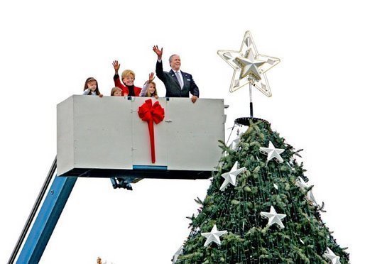 After placing a star on the National Christmas Tree, Lynne Cheney, wife of Vice President Dick Cheney, participates in the annual Pageant of Peace tree-topping tradition with Peter Nostrand, chairman of the Christmas Pageant of Peace program, right, and her three grandchildren (from left): Elizabeth Perry, 7, Grace Perry, 4, Kate Perry, 10, on the Ellipse near the White House Tuesday, Nov. 23, 2004. The 81st lighting of the famous tree takes place Dec. 2, 2004. White House photo by David Bohrer