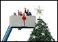 After placing a star on the National Christmas Tree, Lynne Cheney, wife of Vice President Dick Cheney, participates in the annual Pageant of Peace tree-topping tradition with Peter Nostrand, chairman of the Christmas Pageant of Peace program, right, and her three grandchildren (from left): Elizabeth Perry, 7, Grace Perry, 4, Kate Perry, 10, on the Ellipse near the White House Tuesday, Nov. 23, 2004. The 81st lighting of the famous tree takes place Dec. 2, 2004.  White House photo by David Bohrer