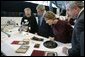 President George W. Bush and Laura Bush get a close look at some of the artifacts at the Canadian National Archives Gatineau Preservation Centre in Gatineau, Québec, Nov. 30, 2004. White House photo by Paul Morse