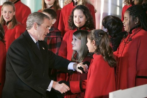 President George W. Bush greets members of the West Tennessee Youth Chorus during the National Christmas Tree lighting ceremony on the Ellipse in front of the White House Dec. 2, 2004. White House photo by Paul Morse.