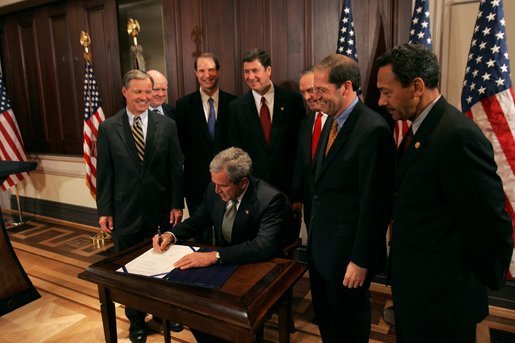 President George W. Bush signs S. 150, The Internet Tax Nondiscrimination Act, in the Eisenhower Executive Office Building Friday, Dec. 3, 2004. Watching the signing are, from left: Congressman Chris Cox, R-Calif.; John Snow, Secretary of the Treasury; Senator Ron Wyden, D-Ore.; Senator George Allen, R-Va.; Don Evans, Secretary of Commerce; Senator John Sununu, R-N.H.; Congressman Mel Watt, D-N.C. White House photo by Tina Hager