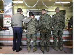 President George W. Bush stands in a chow line with Marines before sitting down for lunch with military personnel at Marine Corps Base Camp Pendleton, Calif., Tuesday, Dec. 7, 2004. White House photo by Eric Draper