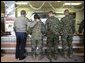 President George W. Bush stands in a chow line with Marines before sitting down for lunch with military personnel at Marine Corps Base Camp Pendleton, Calif., Tuesday, Dec. 7, 2004.White House photo by Eric Draper