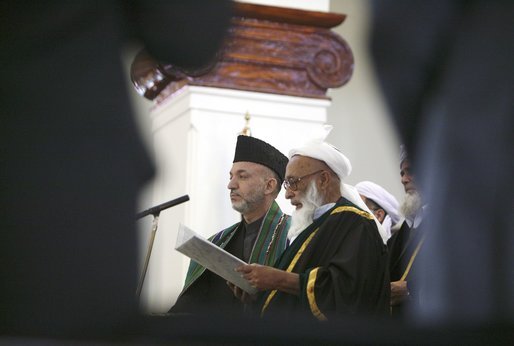 President of Afghanistan Hamid Karzai is sworn in by Afghanistan Supreme Court Chief Justice Fazil Hadi Shinwari during President Karzai’s inauguration ceremony at Salaam Khana in Kabul, Afghanistan, Dec. 7, 2004. White House photo by David Bohrer