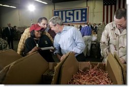 President George W. Bush and Laura Bush visit Operation USO CarePackage at Fort Belvior, Va., Friday, Dec. 10, 2004. "This is one way of saying, America appreciates your service to freedom and peace and our security," said the President in his remarks about the program that has delivered more than 480,000 care packages. White House photo by Paul Morse
