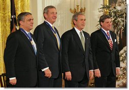 President George W. Bush stands with recipients of the Presidential Medal of Freedom during a ceremony in the East Room Tuesday, Dec. 14, 2004. From left, they are CIA Director George Tenet, Ambassador L. Paul Bremer III and U.S. Army General Tommy R. Franks. White House photo by Tina Hager