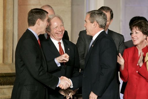 President George W. Bush talks with Senators Bill Frist, R-Tenn., right and Joe Lieberman, D-Conn., during the signing ceremony of S. 2845, The Intelligence Reform and Terrorism Prevention Act of 2004, in Washington, D.C., Dec. 17, 2004. White House photo by Paul Morse