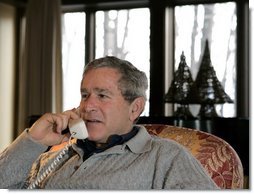 President George W. Bush participates in Christmas Eve Phone Calls to members of the armed forces at Camp David, Friday, Dec. 24, 2004.  White House photo by Eric Draper