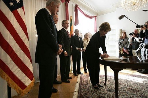 Laura Bush signs a condolence book for the victims of the recent tsunami during a visit to the Embassy of Sri Lanka in Washington, D.C., Monday, Jan. 3, 2005. Also signing to express their condolences are President George W. Bush and former Presidents Clinton and Bush. White House photo by Eric Draper.