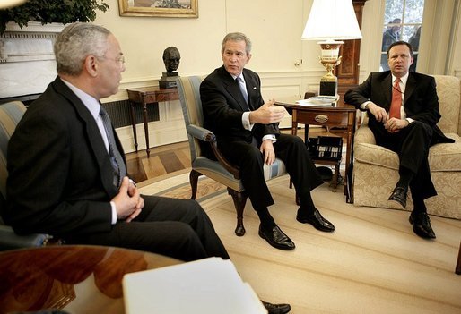 President George W. Bush talks with State Secretary Colin Powell and FEMA Director Mike Brown, far right, during an Oval Office briefing on the tsumami relief efforts Monday, Jan. 10, 2005. White House photo by Eric Draper.