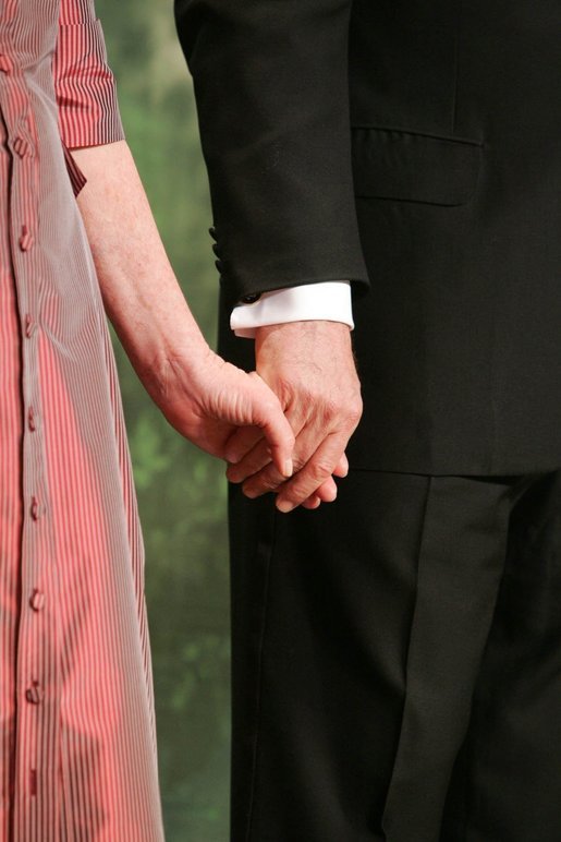 George W. Bush and Laura Bush hold hands during a Black Tie and Boots Ball in Washington, D.C., Jan. 19, 2005. White House photo by Susan Sterner