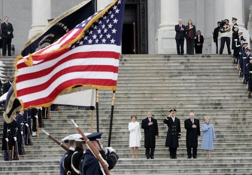 Escorted by Army Major General Galen Jackman, center, President George W. Bush, Laura Bush, Vice President Dick Cheney and Lynne Cheney salute the American flag from the U.S. Capitol steps before President Bush takes the oath of office for a second term as the 43rd President of the United States, Thursday, January 20, 2005. White House photo by Eric Draper