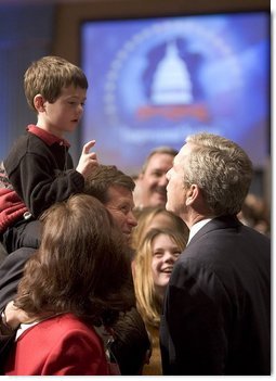 President George W. Bush talks with a young boy prior to delivering remarks on his legislative priorities and initiatives for the 109th Congressional session of Congress during a retreat in White Sulphur Springs, W.V., Friday, Jan. 28, 2005.   White House photo by Paul Morse