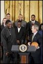 During a ceremony honoring the Detroit Pistons for winning the 2004 NBA Championship, President George W. Bush shares a laugh with basketball player Ben Wallace in the East Room, Jan. 31, 2005. White House photo by Paul Morse.