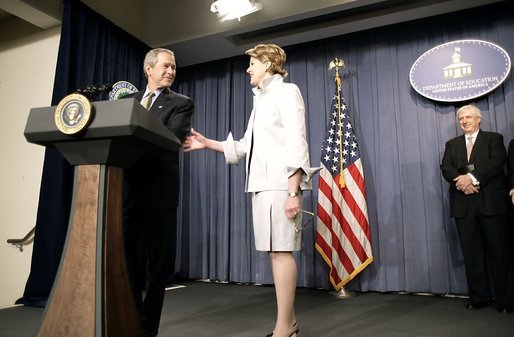 President George W. Bush congratulates Margaret Spellings, the new Secretary of Education, during her swearing-in ceremony at the Department of Education in Washington, D.C., Monday, Jan. 31, 2005. Also pictured, right, is Secretary Spellings husband, Robert Spellings. White House photo by Paul Morse.