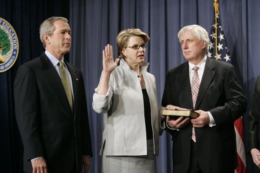 With President George W. Bush and her husband Robert Spellings by her side, Secretary of Education Margaret Spellings takes the oath of office during a ceremony at the Department of Education in Washington, D.C., Monday, Jan. 31, 2005. Secretary Spellings served as an Assistant to the President for Domestic Policy during the first term of the Bush administration. White House photo by Paul Morse.