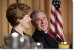 President George W. Bush and Laura Bush laugh during the National Prayer Breakfast in Washington, D.C., Thursday, Feb. 3, 2005.  White House photo by Paul Morse