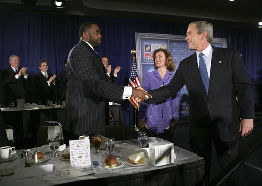 President George W. Bush greets Detroit Mayor Kwame Kilpatrick after delivering remarks at the Detroit Economic Club in Detroit, Michigan, Tuesday, Feb. 8, 2005. Also pictured at center is Detroit Economic Club President Beth Chappell. White House photo by Eric Draper.