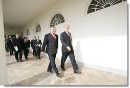 President George W. Bush and Aleksander Kwasniewski, the President of Poland, walk along the colonnade to the Oval Office Wednesday, Feb. 9, 2005.  White House photo by Eric Draper