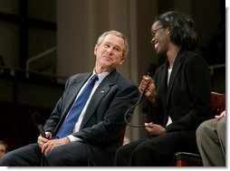 President George W. Bush and Dawn Baldwin, an English teacher at Lenior Community College in Kinston, N.C., exchange smiles during a town hall meeting on strengthening Social Security in Raleigh, N.C., Thursday, Feb. 10, 2005.  White House photo by Eric Draper