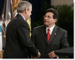Attorney General Alberto Gonzales receives congratulations from President Bush during ceremonies Monday, Feb. 14, 2005, marking Mr. Gonzales's new post.  White House photo by Paul Morse
