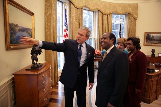 President George W. Bush and Laura Bush meet with Paul Rusesabagina and his wife, Tatiana, in the Oval Office Thursday, Feb. 17, 2005. The subject of the film, Hotel Rwanda, Mr. Rusesabagina sheltered refugees in a Rwandan hotel where he worked as a manager. White House photo by Eric Draper