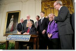 President George W. Bush signs S. 5, the Class Action Fairness Act of 2005, during a ceremony in the East Room, Friday, Feb. 18, 2005.  White House photo by Eric Draper