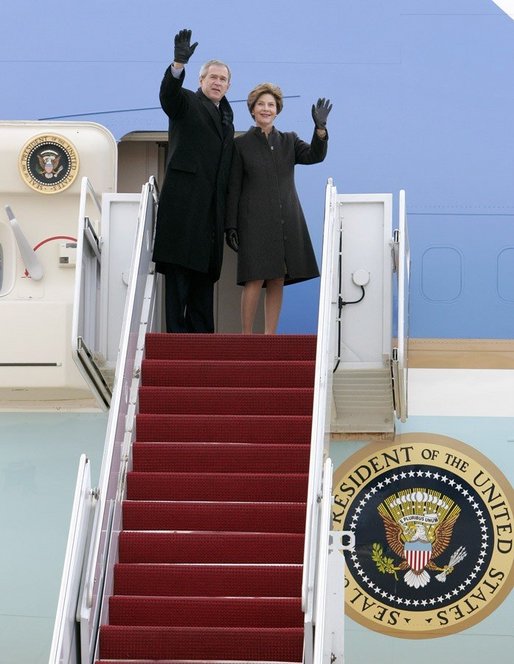 President George W. Bush and Laura Bush wave from the Air Force One stairs en route Brussels, Belgium, Sunday, Feb. 20, 2005. President Bush and Laura Bush flew from Andrews Air Force Base in Maryland to Belgium, beginning a five-day trip to Belgium, Germany and Slovakia. White House photo by Eric Draper