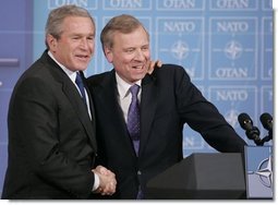 President George W. Bush is welcomed by NATO Secretary General Jaap de Hoop Scheffer during a news conference Tuesday, Feb. 22, 2005, at NATO Headquarters in Brussels.  White House photo by Paul Morse