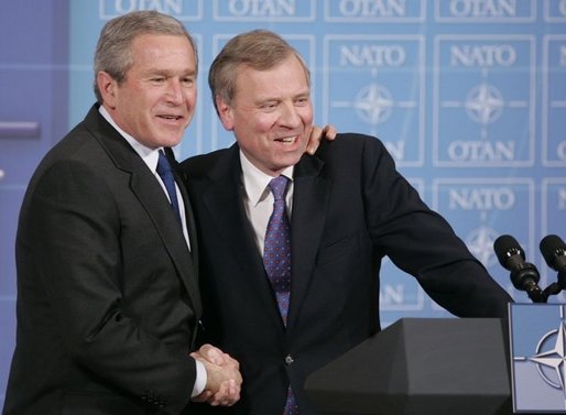 President George W. Bush is welcomed by NATO Secretary General Jaap de Hoop Scheffer during a news conference Tuesday, Feb. 22, 2005, at NATO Headquarters in Brussels. White House photo by Paul Morse